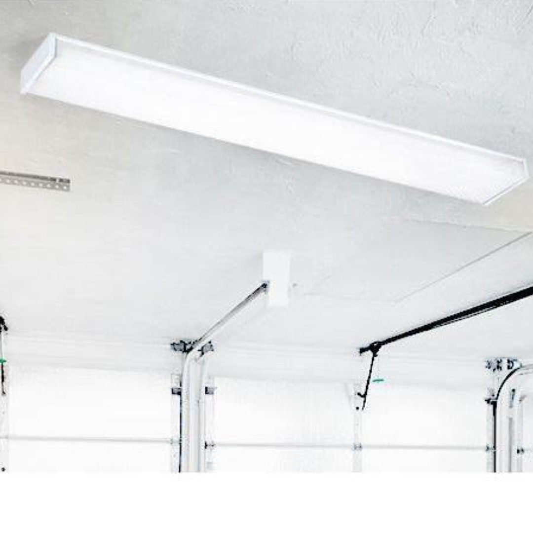 Fluorescent-style LED wraparound ceiling light fixture mounted in a white garage ceiling with visible garage door tracks