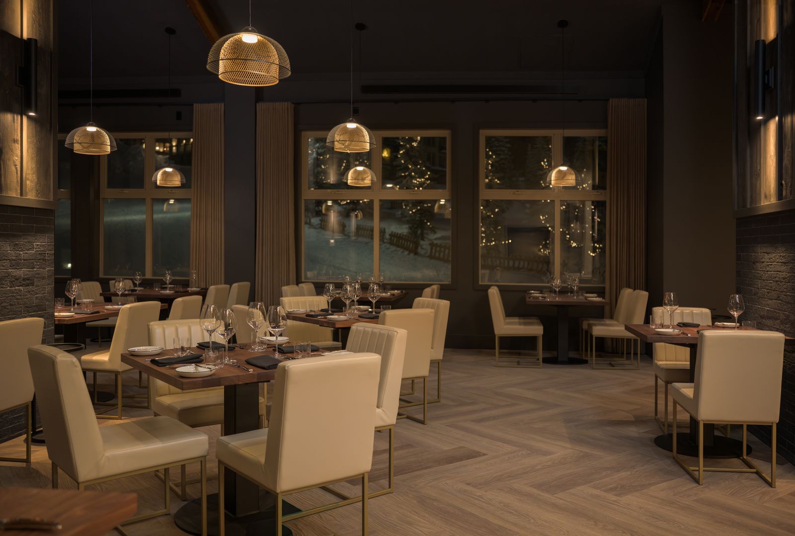 Elegant dining room lighting inside Kettle Valley Steakhouse at Big White Ski Resort with warm pendant lighting and luxury restaurant ambiance.
