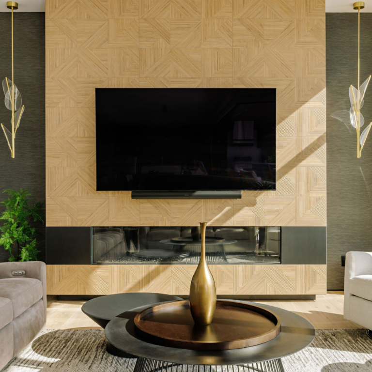 Contemporary living room with geometric wood fireplace feature wall, linear fireplace, large mounted TV, sculptural coffee table, and modern gold pendant lighting in a luxury Kelowna home.
