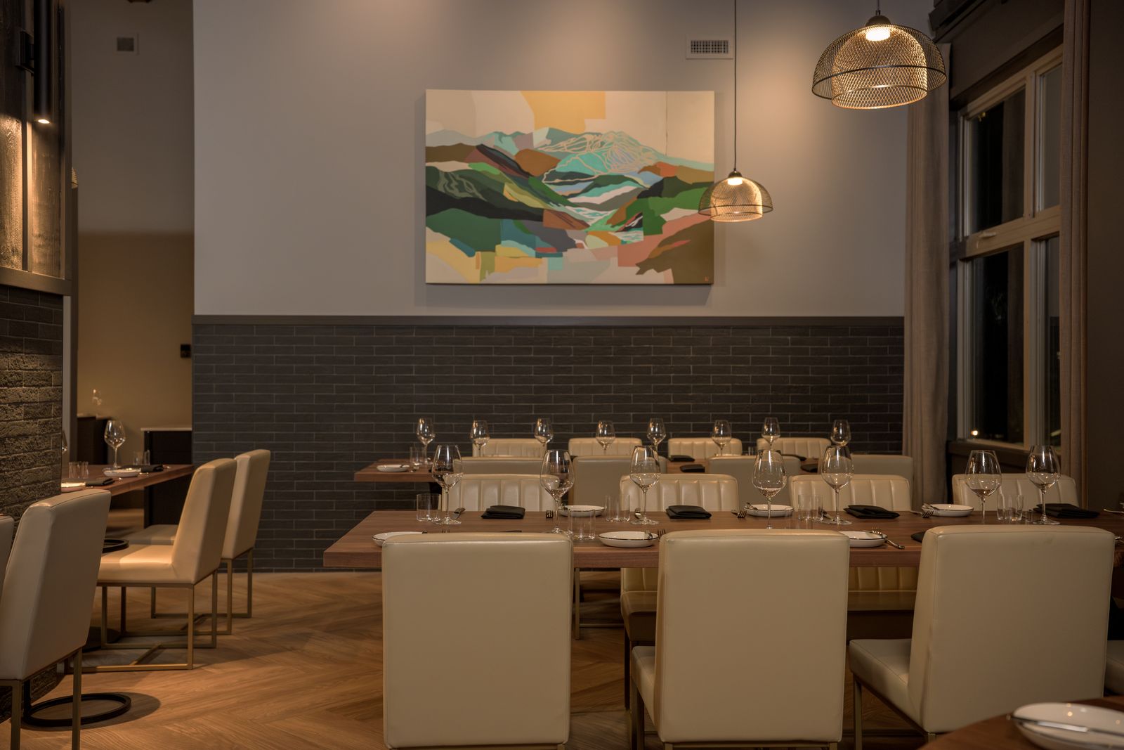 Interior dining area at Kettle Valley Steakhouse featuring layered restaurant lighting and upscale hospitality design at Big White Ski Resort.